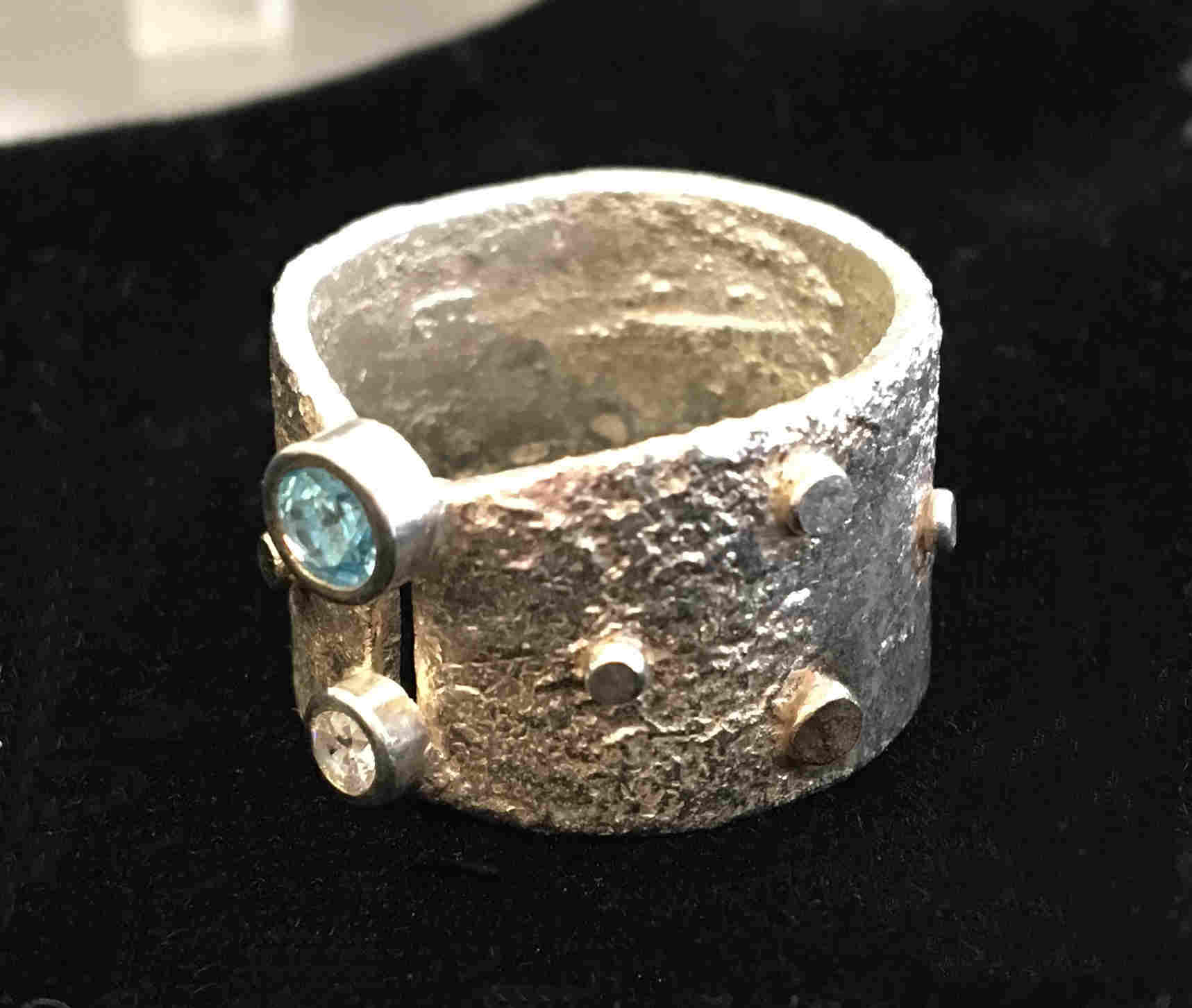 'Sterling Silver reticulated Ring with 1 Clear stone, 1 Swiss Blue Topaz and 9ct Gold Detail' by artist Carol Docherty